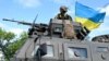 Ілюстраційне фото. Український військовослужбовець стоїть на верху бронеавтомобіля «Козак-2М» біля Краматорська на Донеччині, 14 липня 2022 року