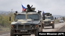Nagorno-Karabakh - Armored vehicles of Russian peacekeepers move along the road towards Agdam from their checkpoint outside Askeran (file photo). 