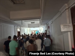 Angajați ai Ministerului de Finanțe protestează pe holul instituției publice.