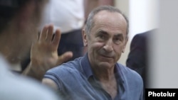 Former Armenian President Robert Kocharian waves to supporters during his trial, Yerevan, September 20, 2019.